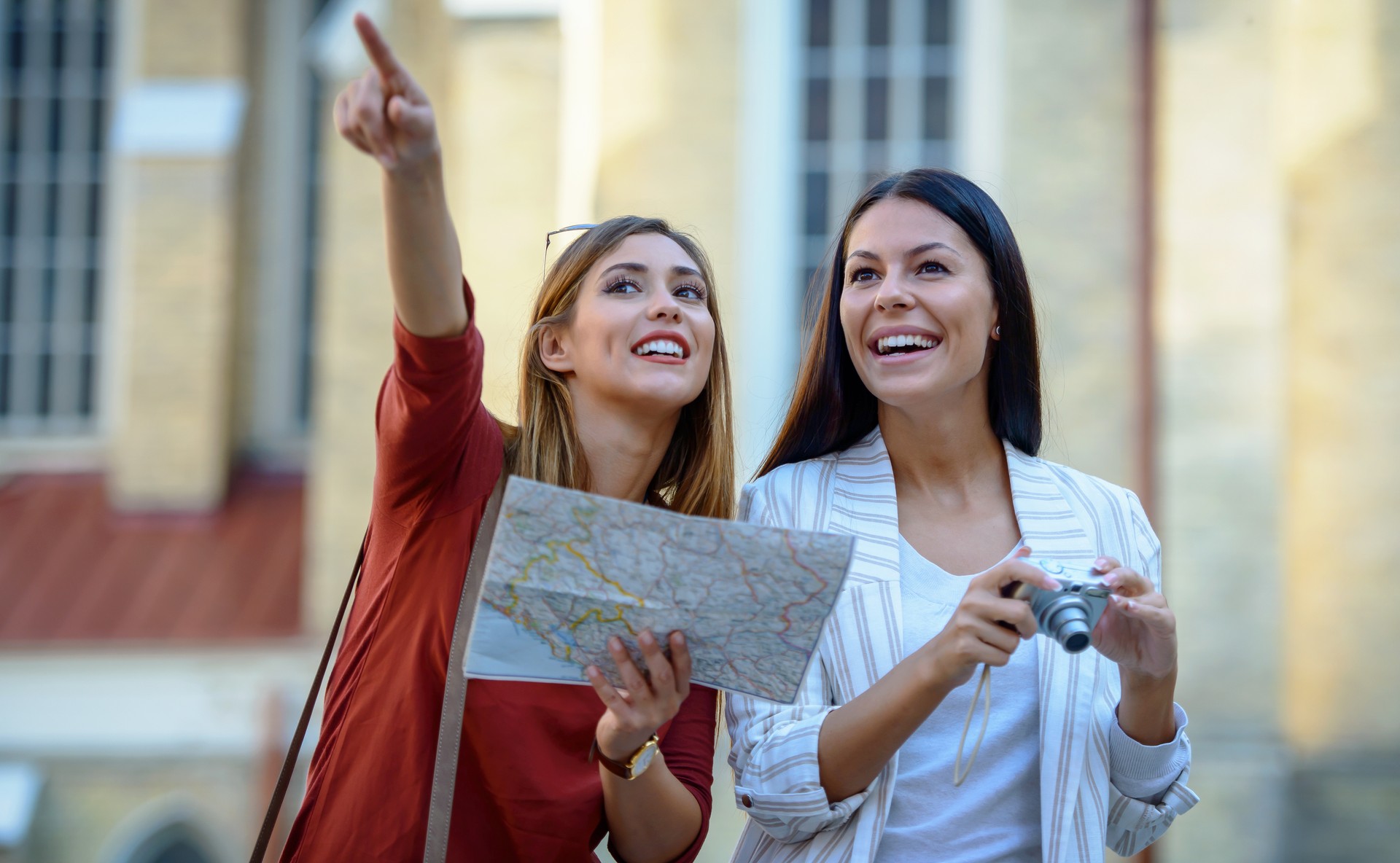 Young tourists enjoying on vacation, having fun together in the city. Concept of tourism