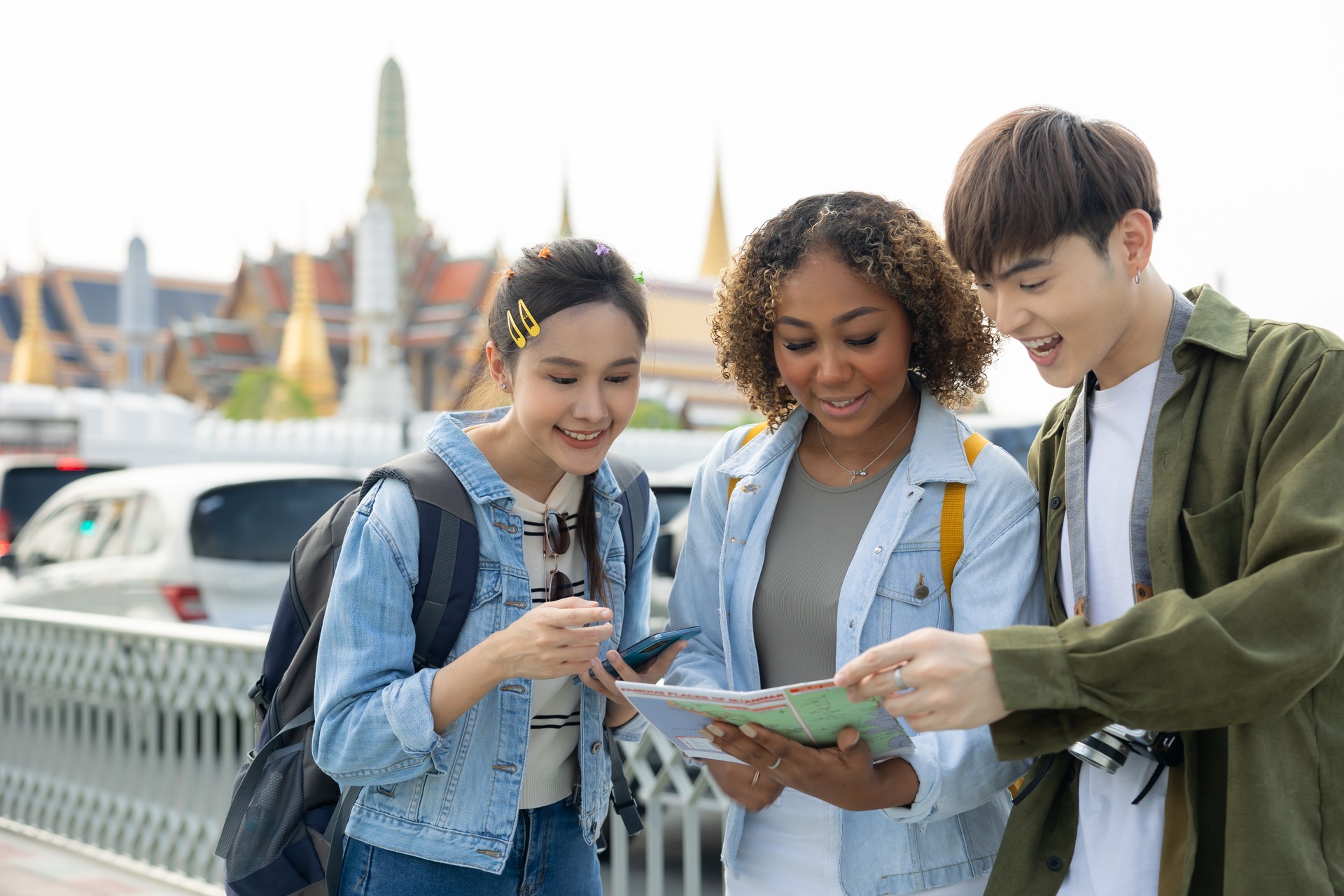 Group of  people tourist travel Temple in Thailand.Young tourist women exploring in the city of southeast Asia by using map for navigate to destination.